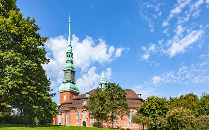 St. Georg Church with its tall spire under a blue sky, Hamburg.