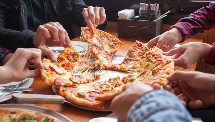 Group sharing pizza at a restaurant