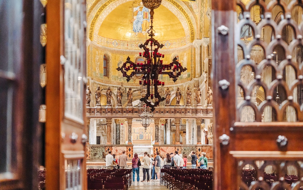 Visitors inside St. Mark's Basilica during an exclusive after-hours tour in Venice.