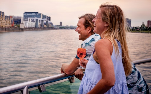 Couple enjoying a sunset view on a Cologne evening panorama cruise.