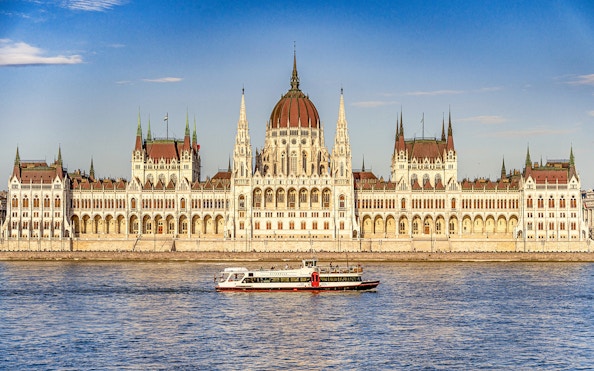 Sightseeing cruise on the Danube River with Budapest Parliament in the background.