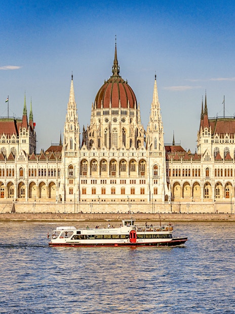 Sightseeing cruise on the Danube River with Budapest Parliament in the background.