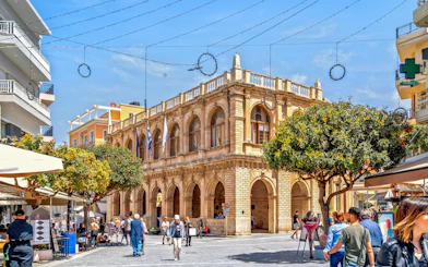 Enetiki Loggia in Heraklion city center with people walking nearby.