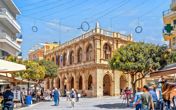 Enetiki Loggia in Heraklion city center with people walking nearby.