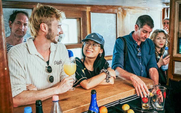 People enjoying drinks on a Berlin bridge cruise along the Spree and Landwehrkanal.