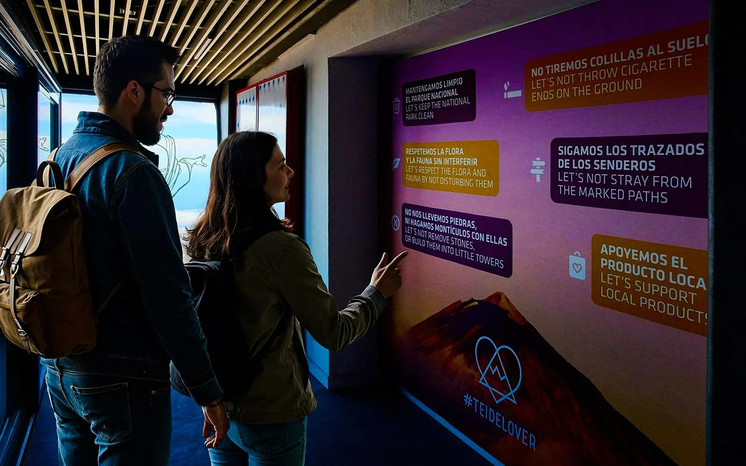 Guests reading informational signs on Mount Teide cable car tour.