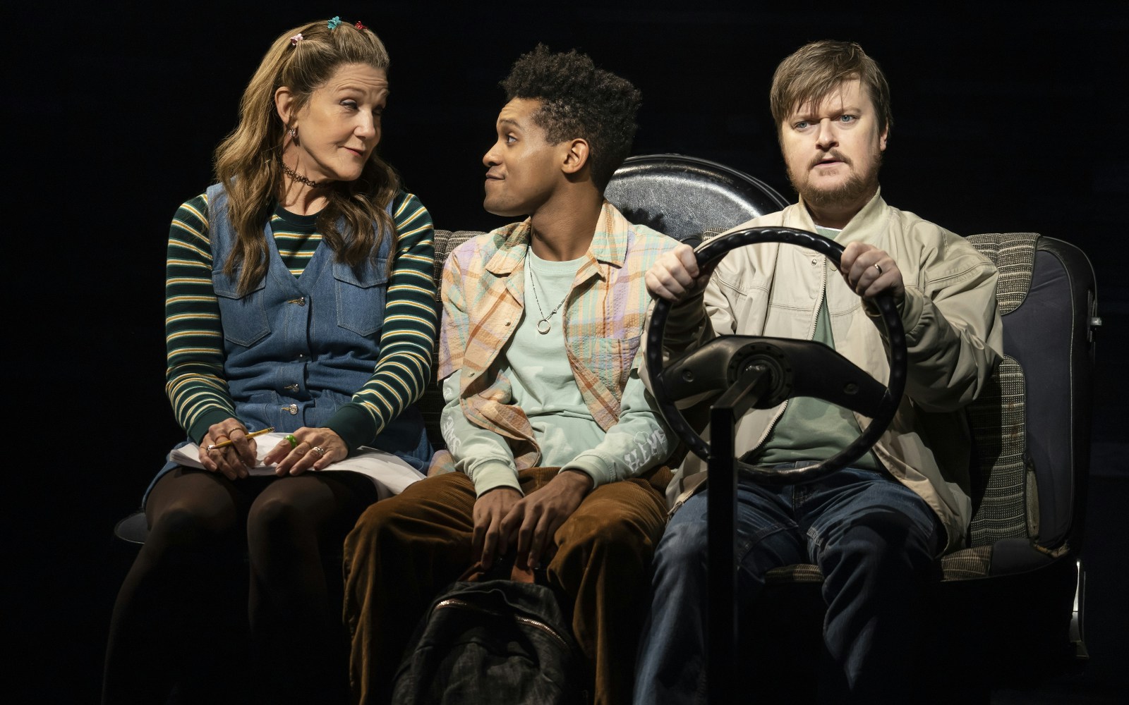 Three people sitting in a car, central to the "Kimberly Akimbo" show experience.