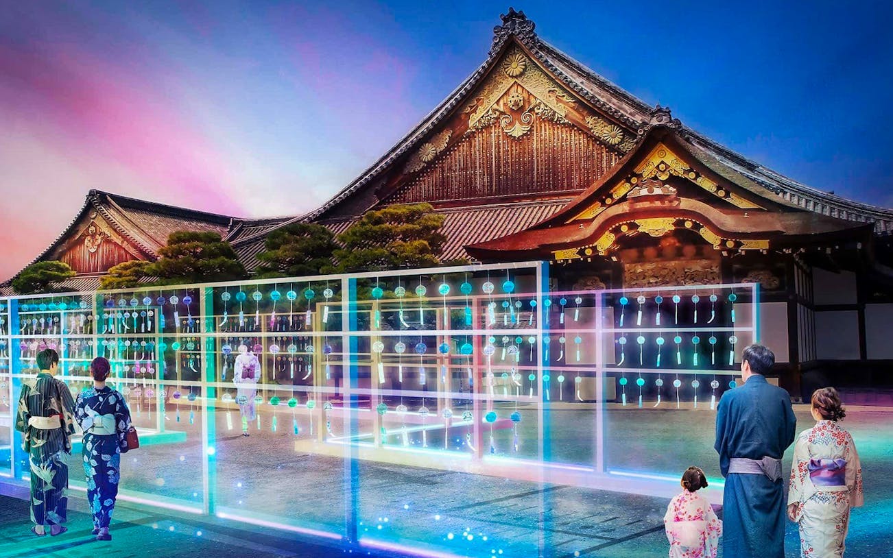 Visitors in traditional attire at Nijo-jo Castle during NAKED Summer Festival 2024, Kyoto.