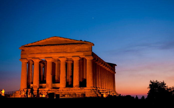 Valley of the Temples, Italy, illuminated at night with a clear sky.