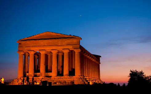 Valley of the Temples, Italy, illuminated at night with a clear sky.