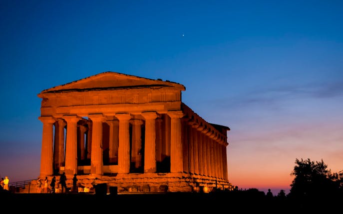Valley of the Temples, Italy, illuminated at night with a clear sky.