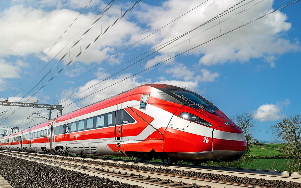 Trenitalia high-speed train traveling through Italian countryside.