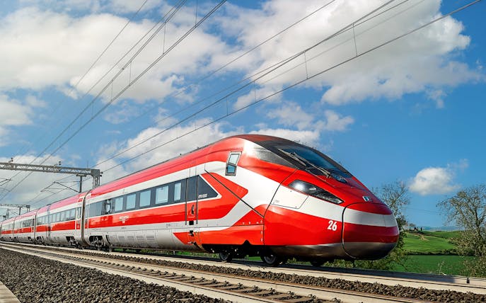 Trenitalia high-speed train traveling through Italian countryside.