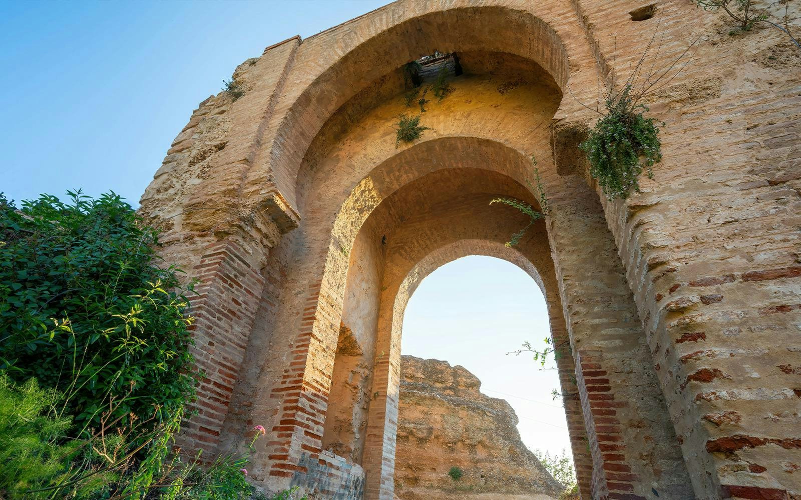 Arabic arch with stone and brickwork in Ronda, Andalusia, Spain.