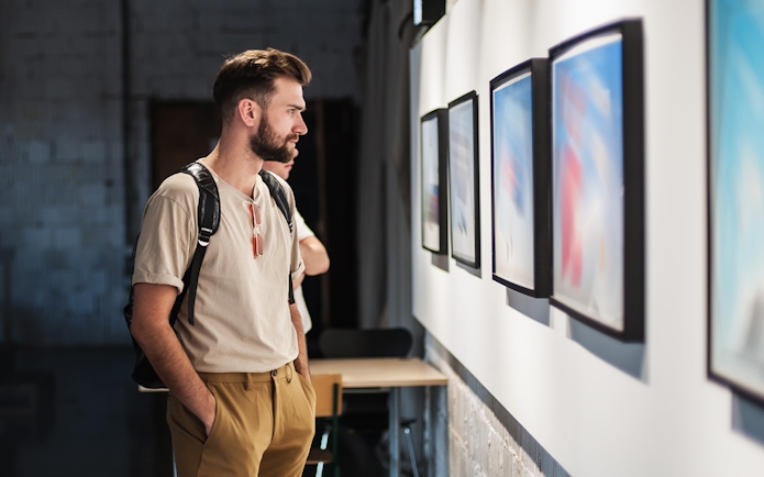 Visitor observing artwork in Galleria Corsini, Rome.