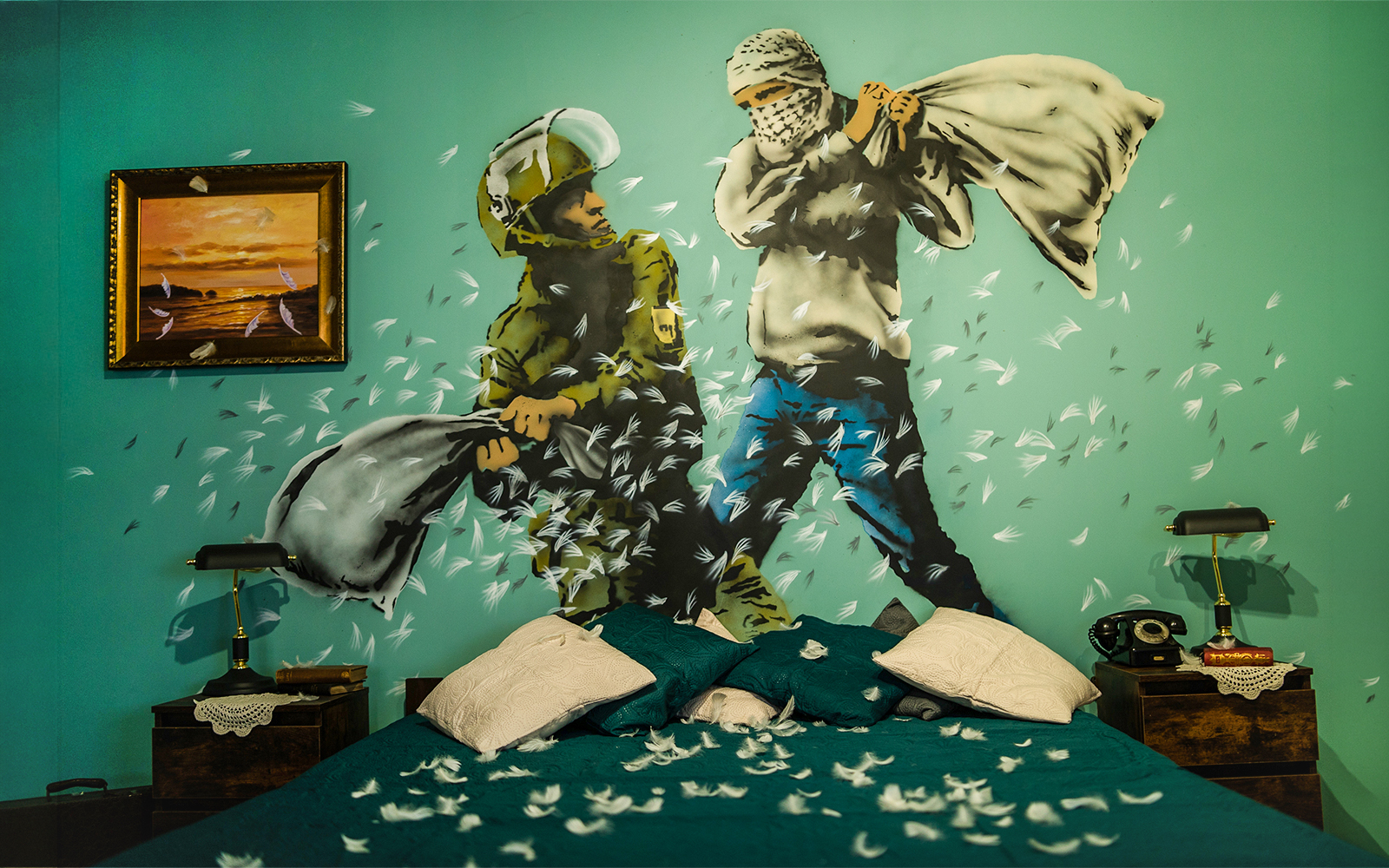 Wall mural of a pillow fight by Banksy at the Banksy Museum in Krakow.