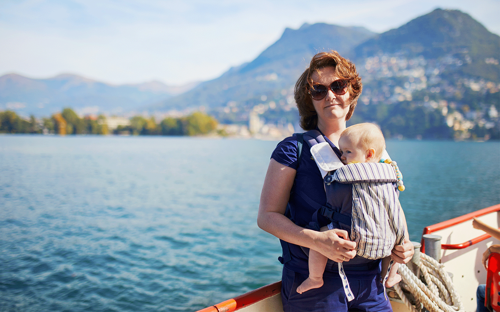 Woman with baby enjoying scenic view on ferry