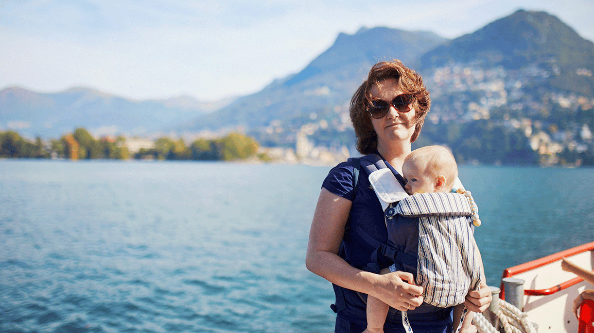 Woman with baby enjoying scenic view on ferry