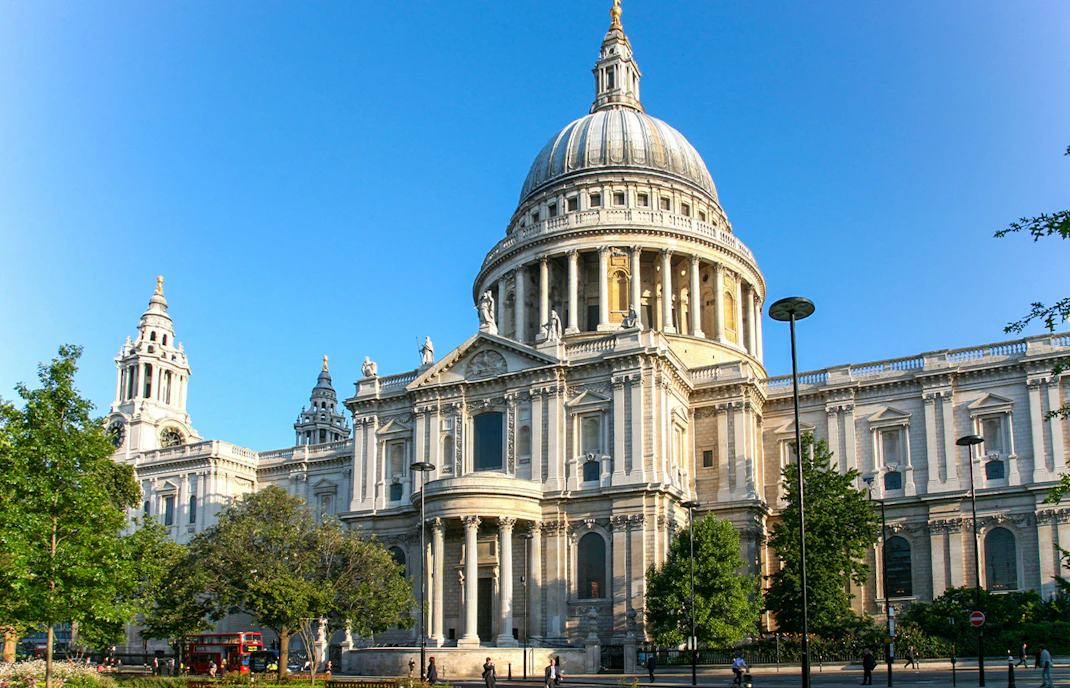 St Paul's Cathedral in London with its iconic dome and surrounding greenery.