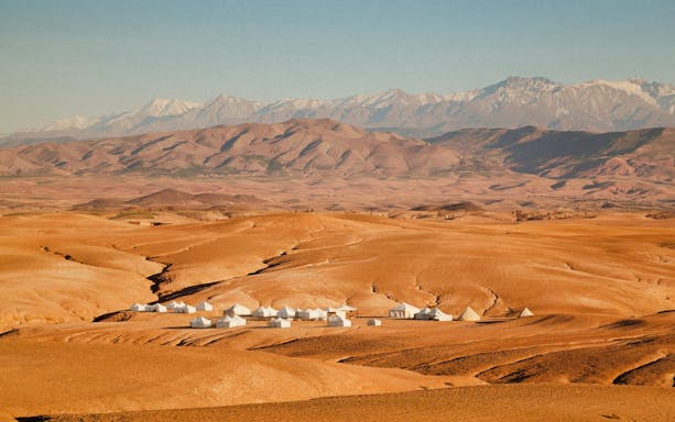 Desert landscape with tents in Agafay, Morocco, ideal for quad biking adventures.