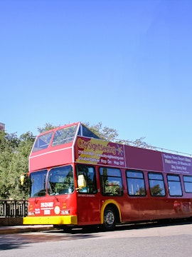 Red double-decker bus for city sightseeing in Palermo.
