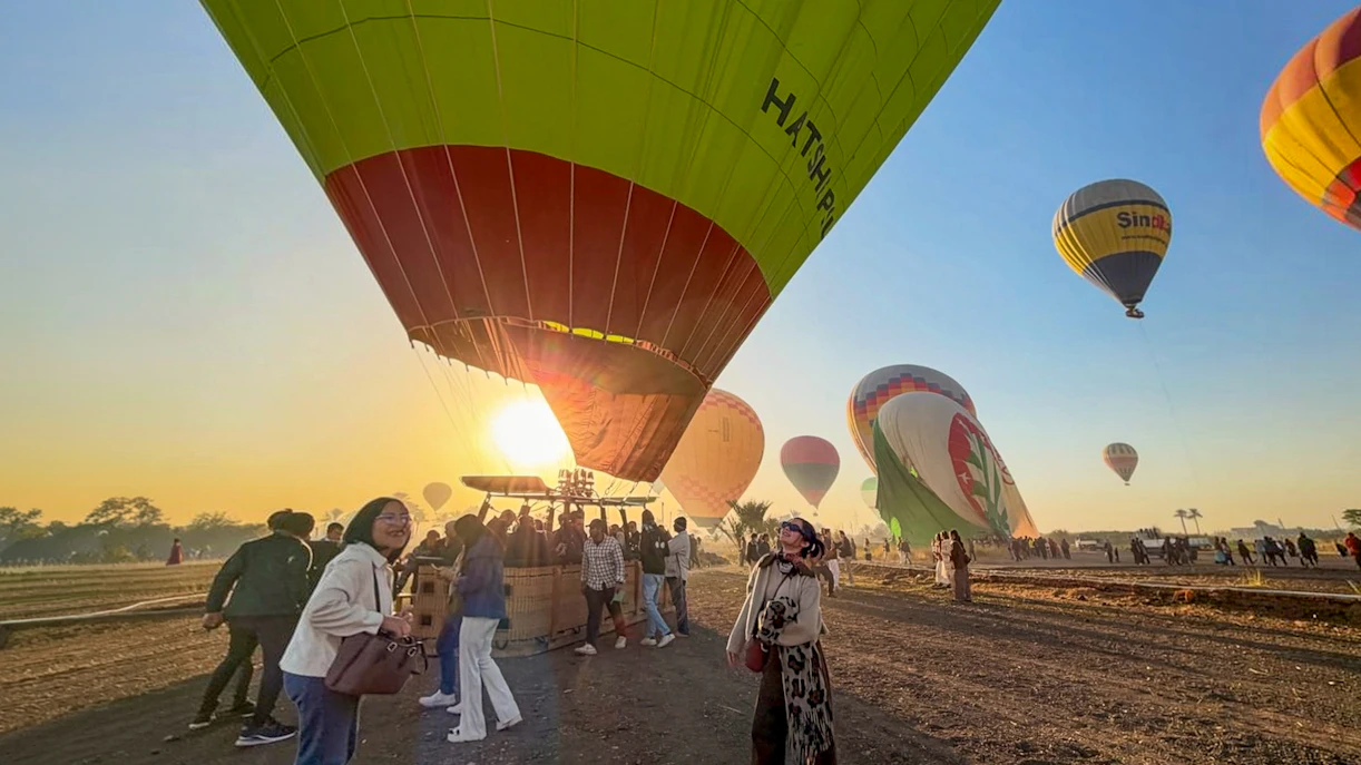 Hot air balloons preparing for flight at sunrise in Luxor, Egypt.