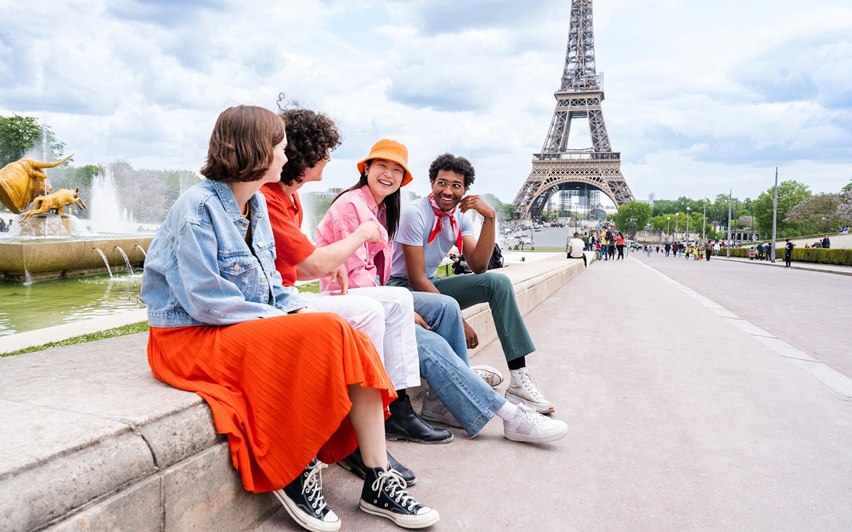 Participants sitting near Eiffel Tower during Paris city tour.