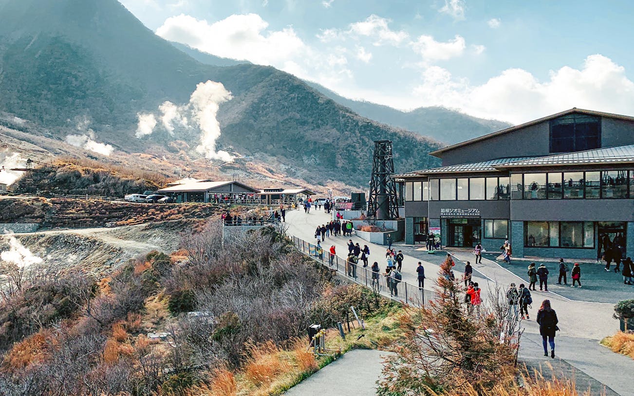 Tourists exploring Owakudani Valley with steaming vents on Mt Fuji and Hakone 1-Day Bus Tour.