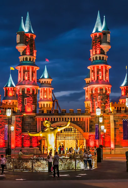 Vialand Theme Park entrance with illuminated castle towers at night.