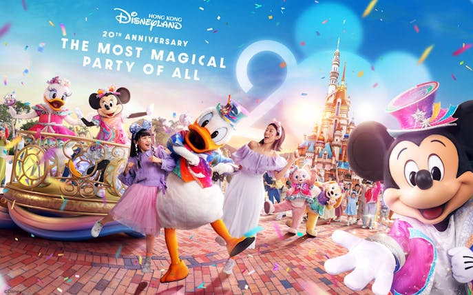Characters celebrating 20th Anniversary at Hong Kong Disneyland with castle in background.