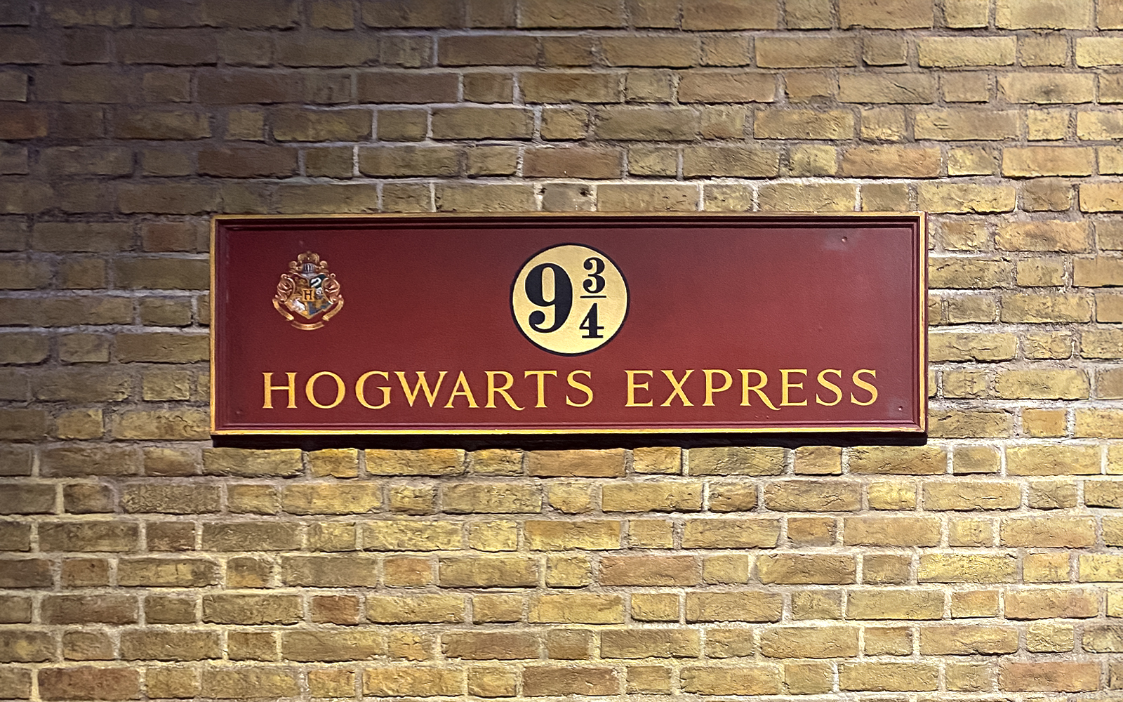 Visitors exploring Platform 9¾ at Harry Potter Studio Tour, London.