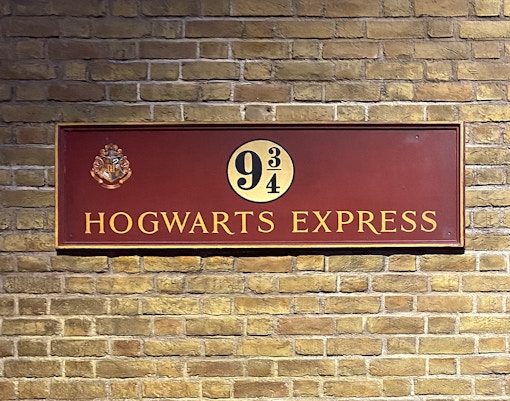 Visitors exploring Platform 9¾ at Harry Potter Studio Tour, London.