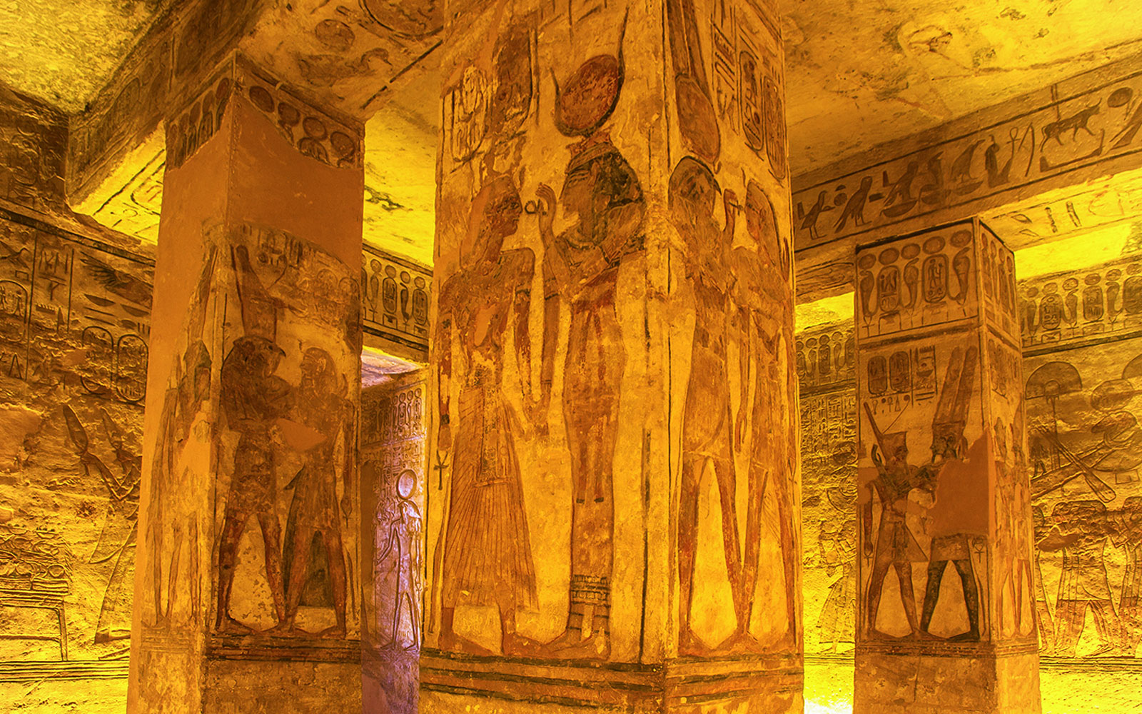 Abu Simbel Temple interior with ancient Egyptian hieroglyphs and carvings on columns.