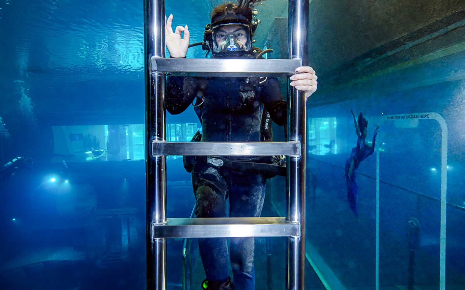 Diver exploring underwater structure during Sunken City Walk.