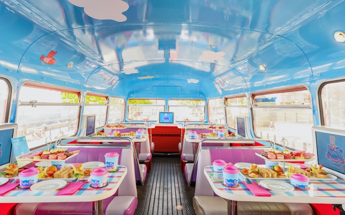 Peppa Pig themed bus interior with tables set for Brigit’s Afternoon Tea Bus Tour.