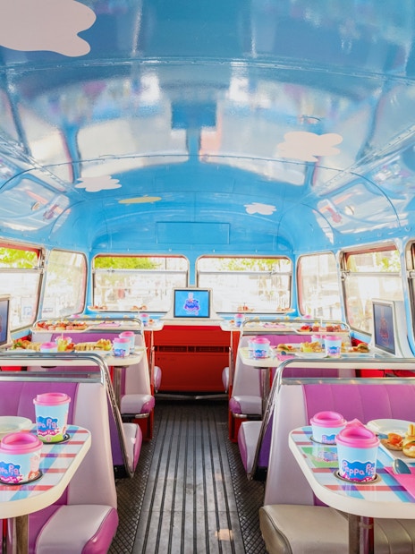 Peppa Pig themed bus interior with tables set for Brigit’s Afternoon Tea Bus Tour.