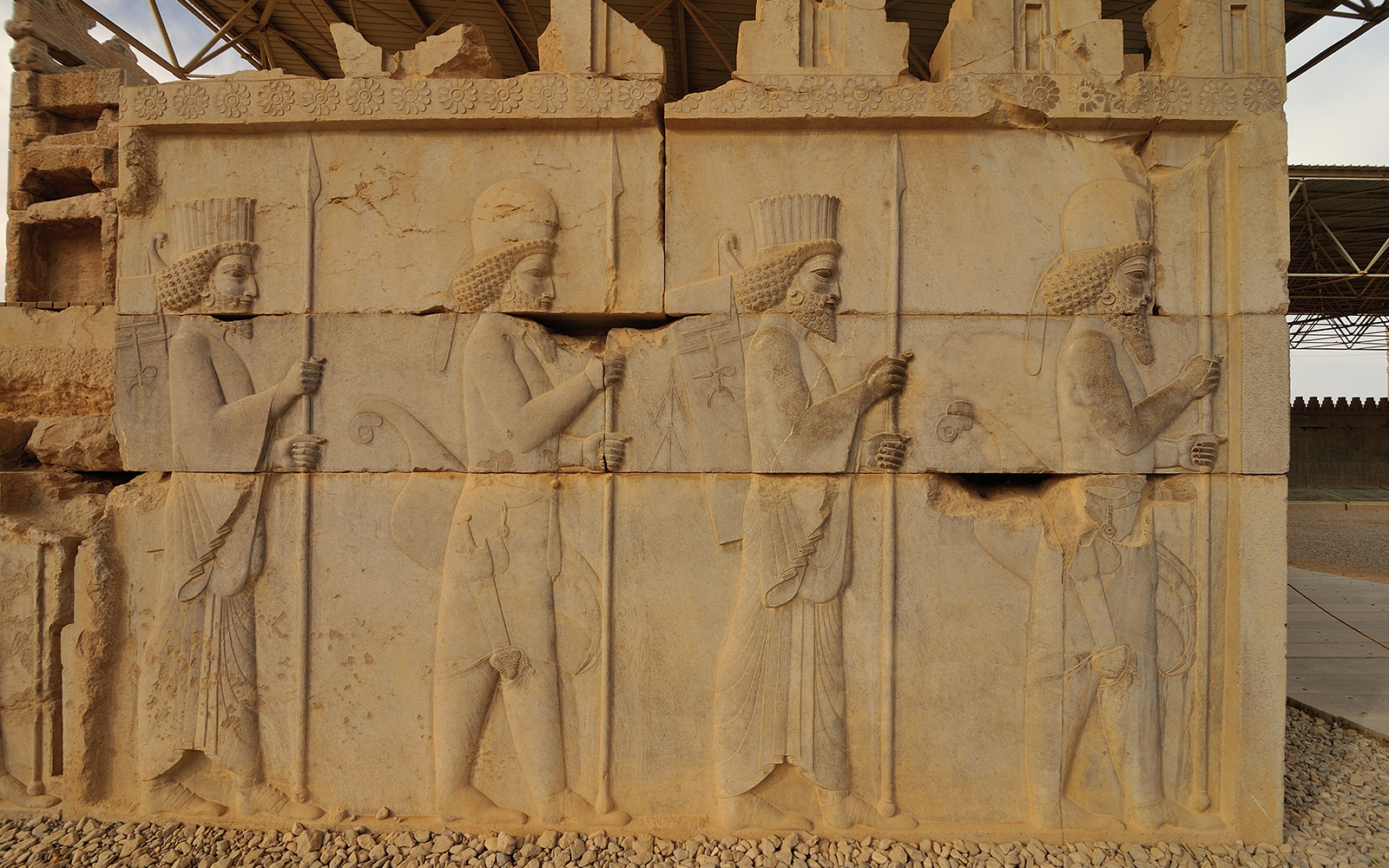 Stone bas-relief of Assyrian warriors with spears at ruins of Persepolis