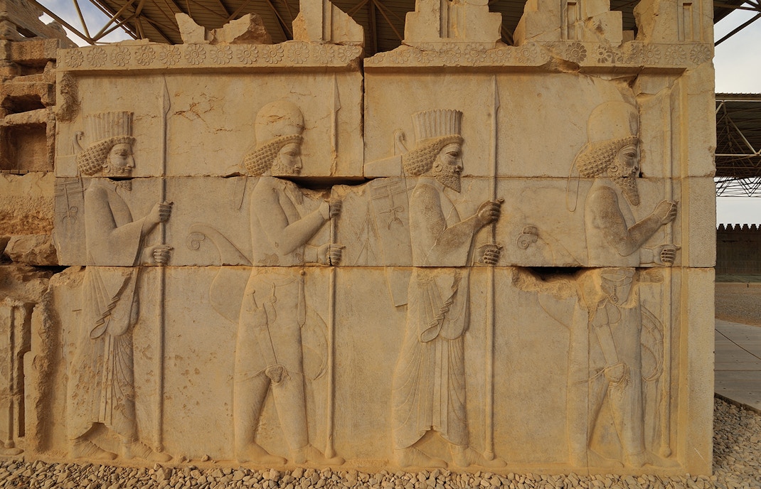 Stone bas-relief of Assyrian warriors with spears at ruins of Persepolis