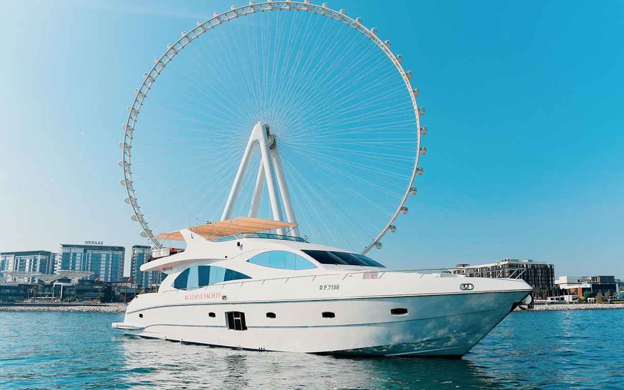 Bluewater yacht with Ain Dubai Wheel in the background on a sunny day.