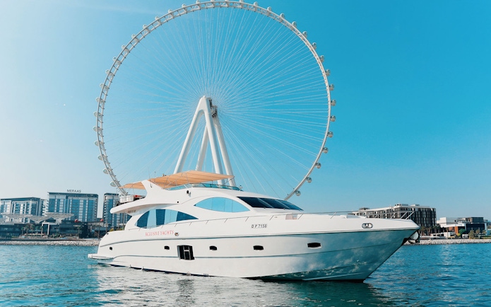 Bluewater yacht with Ain Dubai Wheel in the background on a sunny day.