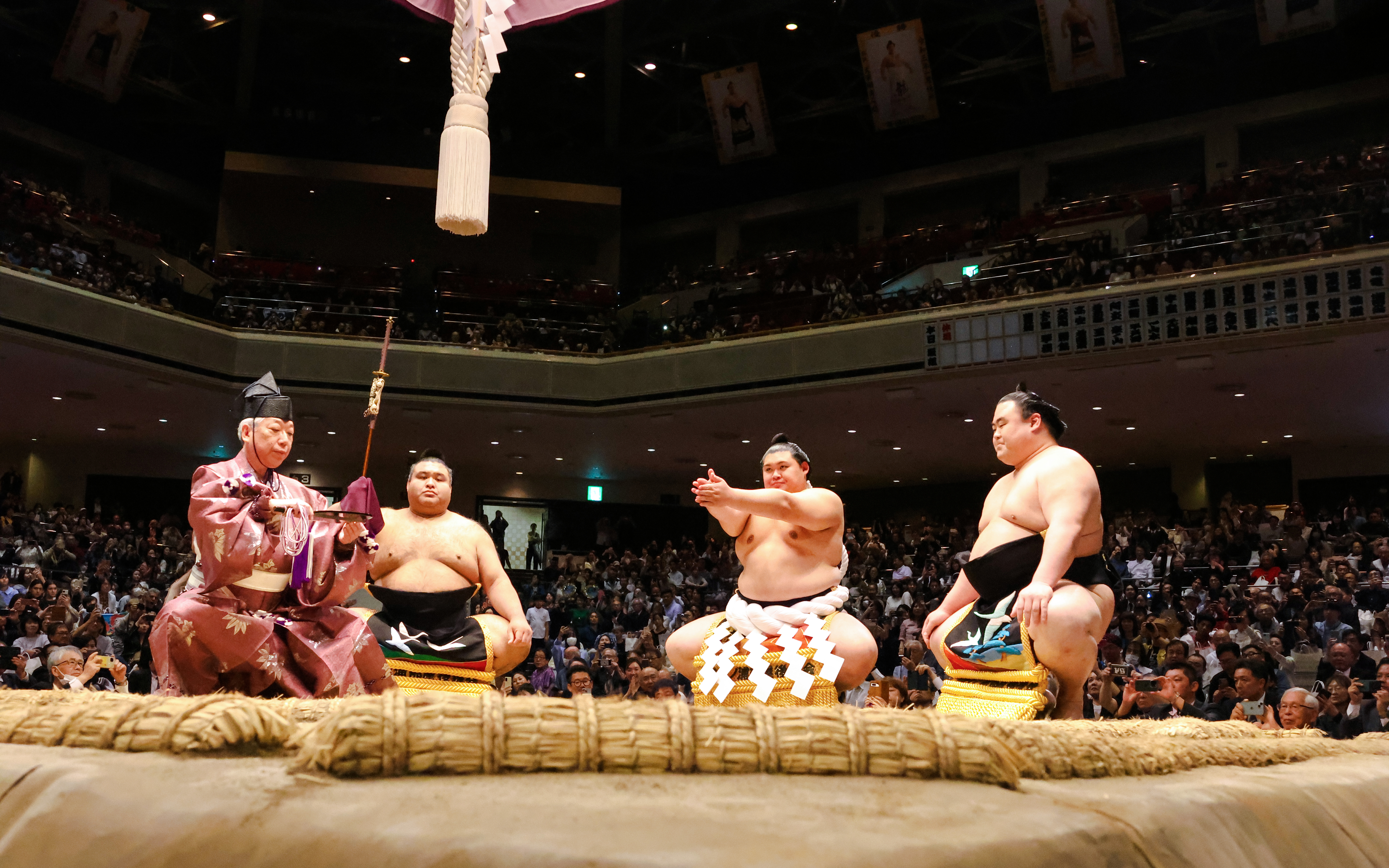 Sumo wrestlers and referee in the ring at Nagoya Grand Sumo Tournament.