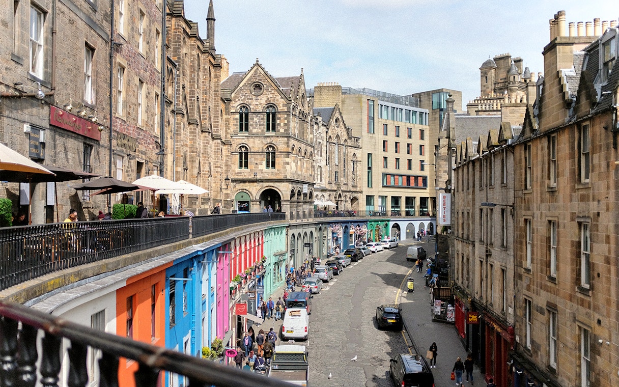 Victoria Street in Edinburgh with colorful shops and historic architecture.