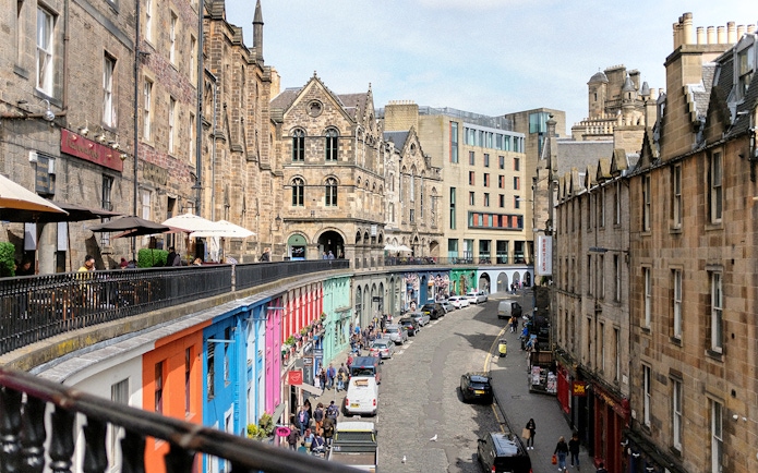 Victoria Street in Edinburgh with colorful shops and historic architecture.