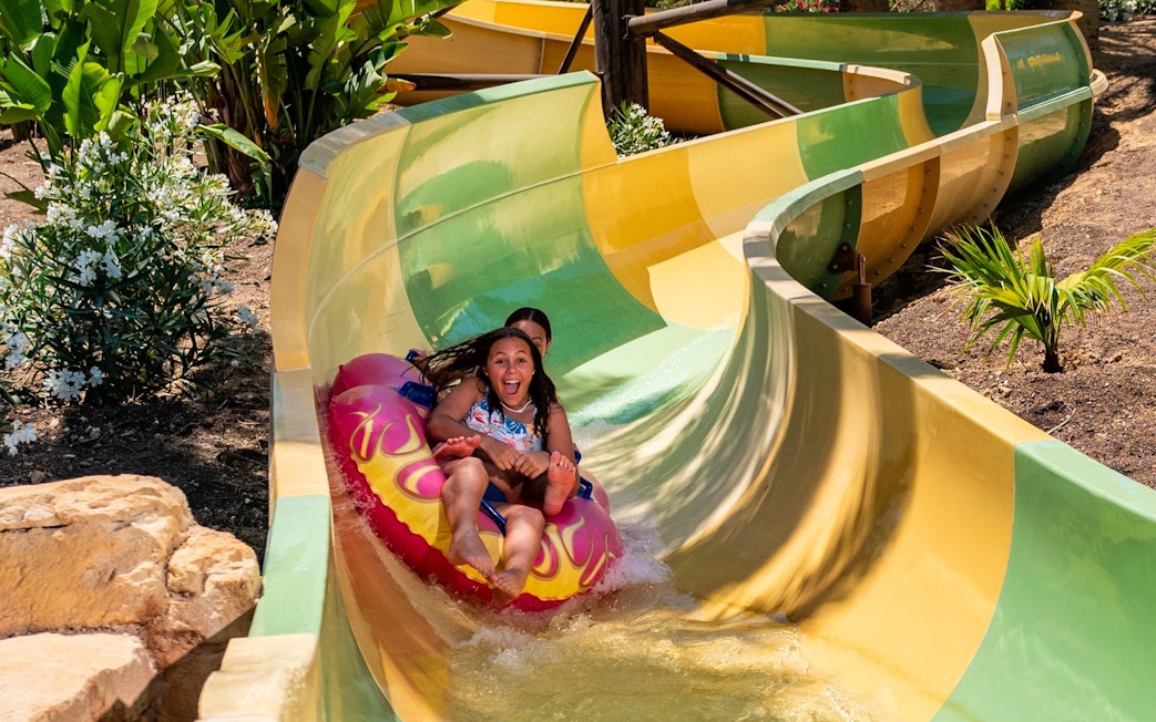 Children enjoying the Tsunami water slide at Aqualand Torremolinos.