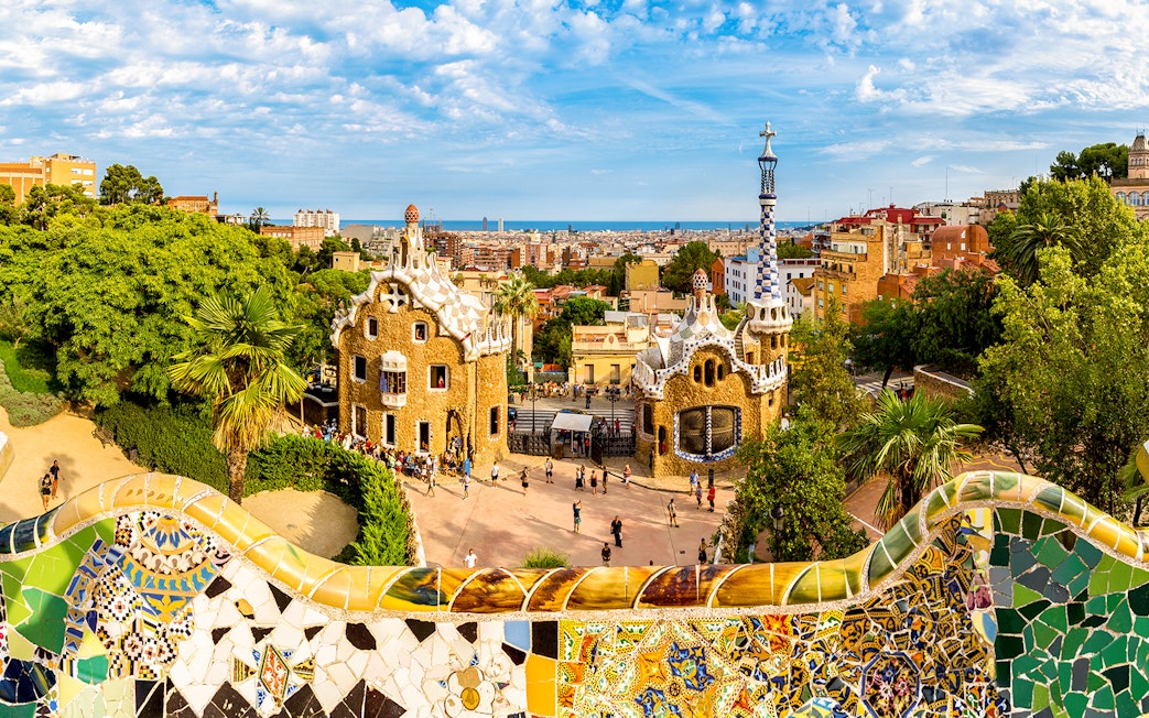 Park Güell entrance with colorful mosaic tiles and unique architecture in Barcelona.