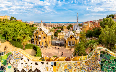 Park Güell entrance with colorful mosaic tiles and unique architecture in Barcelona.