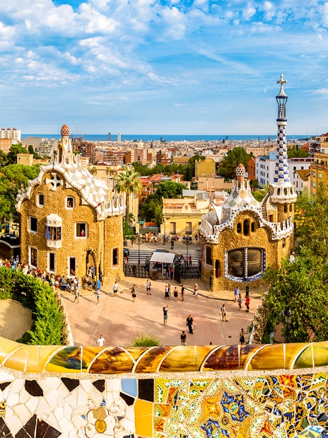 Park Güell entrance with colorful mosaic tiles and unique architecture in Barcelona.