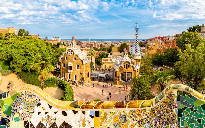 Park Güell entrance with colorful mosaic tiles and unique architecture in Barcelona.
