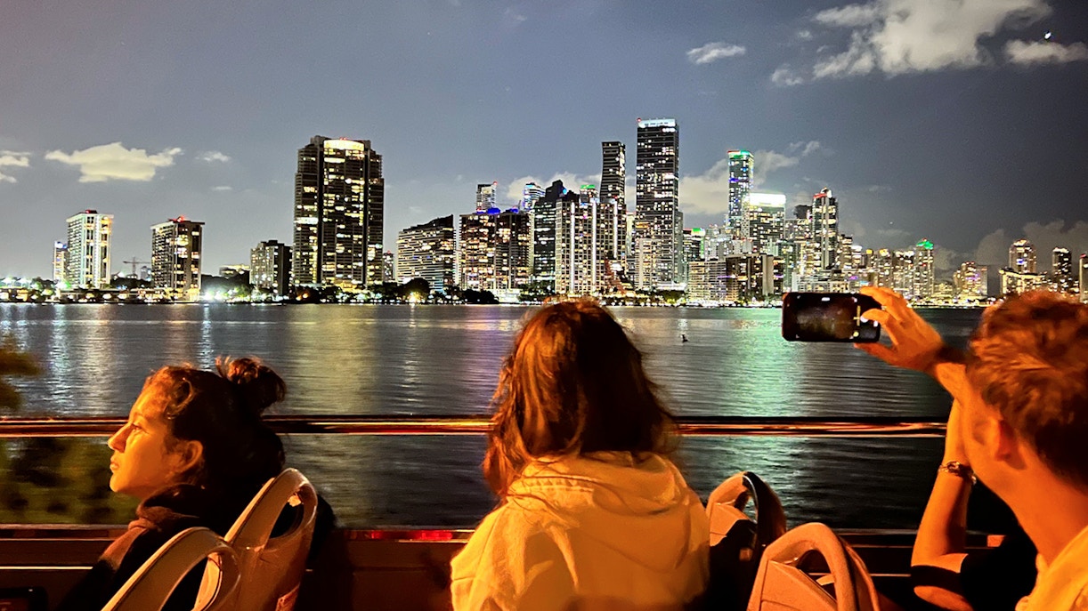 Passengers enjoying the Big Bus Miami Panoramic Night Bus Tour, viewing Miami's illuminated skyline and landmarks