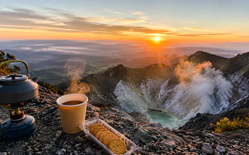 Sunrise view from Mount Sibayak with steaming coffee and biscuits, Medan.